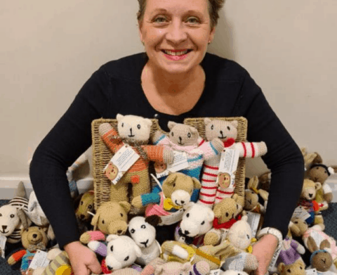 Karen Williams surrounded by knitted bears