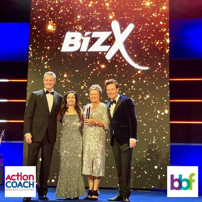 Karen Williams Co Founder of The Buddy Bag Foundation on stage accepting an award from BixZ for Non Profit Business.